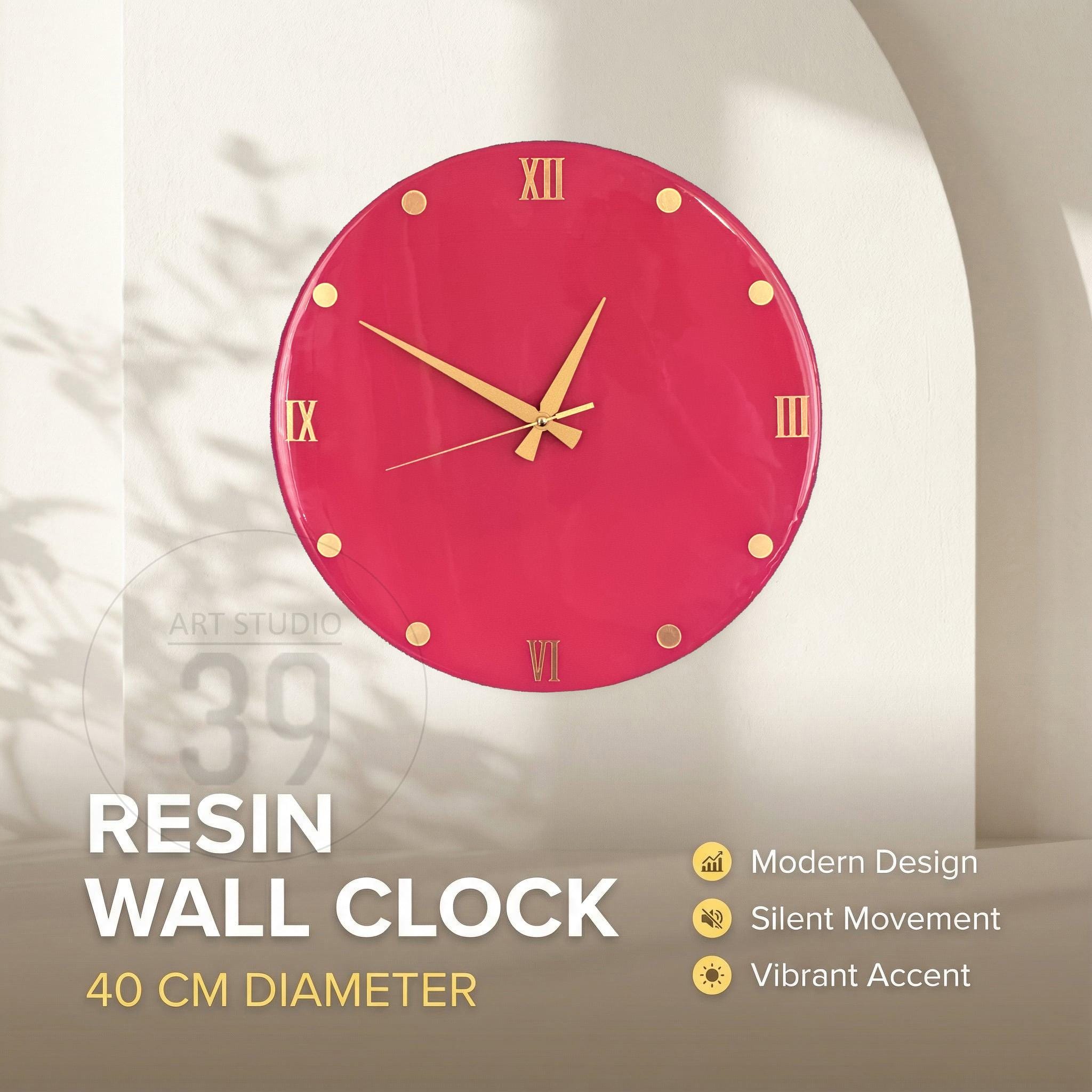 A round, magenta resin wall clock with gold-colored hands and hour markers. The clock face features Roman numerals and is 40 cm in diameter. The text "RESIN WALL CLOCK" is displayed below the clock.