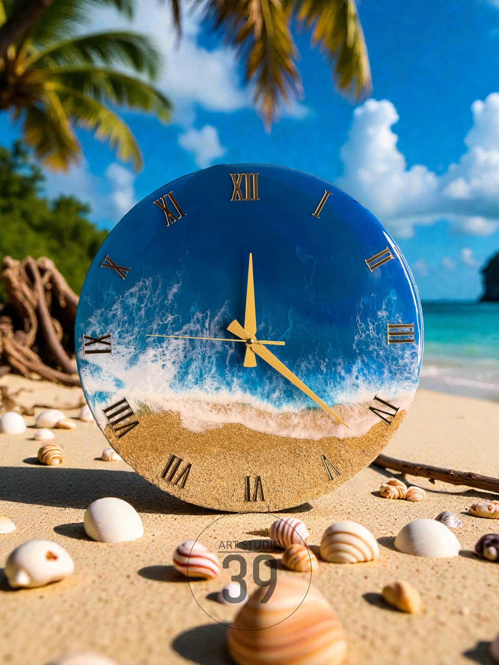 A round wall clock with a beach scene design. The clock face features a blue ocean with white waves and a sandy beach. Gold Roman numerals and clock hands complete the design. The clock is surrounded by seashells.