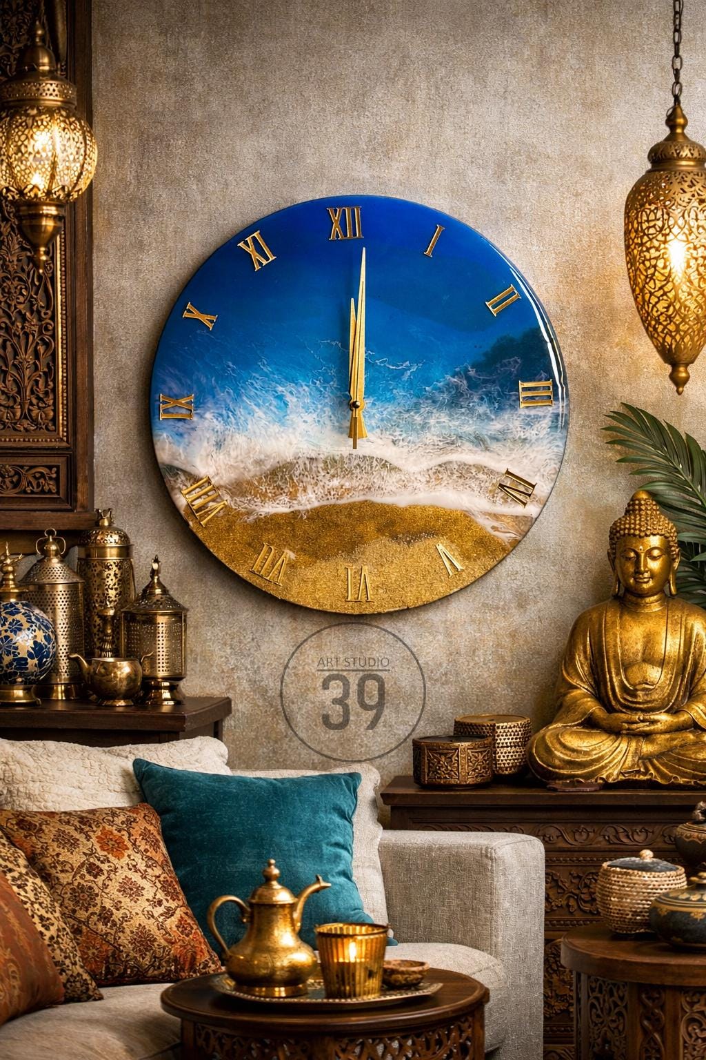 A round wall clock with a beach scene design. The clock face features a blue ocean and golden sand, with gold Roman numerals and hands. The clock measures approximately 24 inches in diameter.