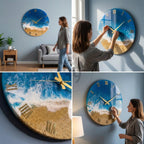 Round wall clock with a beach-themed design. The clock face features a blue ocean, white waves, and a sandy beach. Gold Roman numerals mark the hours, and gold hands indicate the time. The clock is approximately 16 inches in diameter.