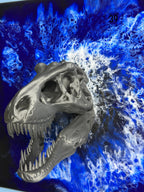 A metallic gray Tyrannosaurus Rex skull sculpture with sharp teeth, set against a vibrant blue and white abstract background. The number "39" is visible in the upper right corner.