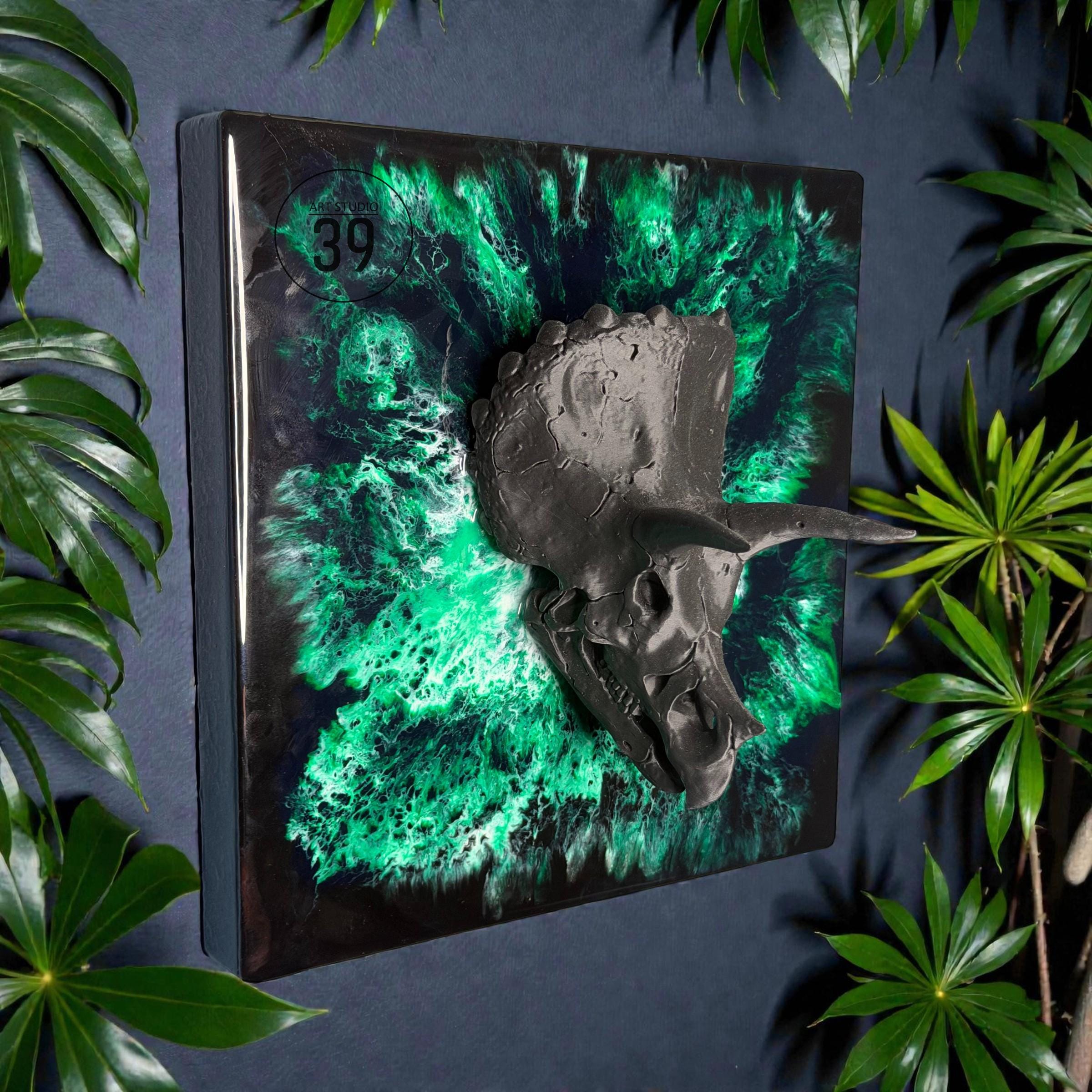 A square wall art piece featuring a dark gray Triceratops skull emerging from a vibrant green and black background. The number "39" is visible in the upper left corner. The artwork is framed in a black border.