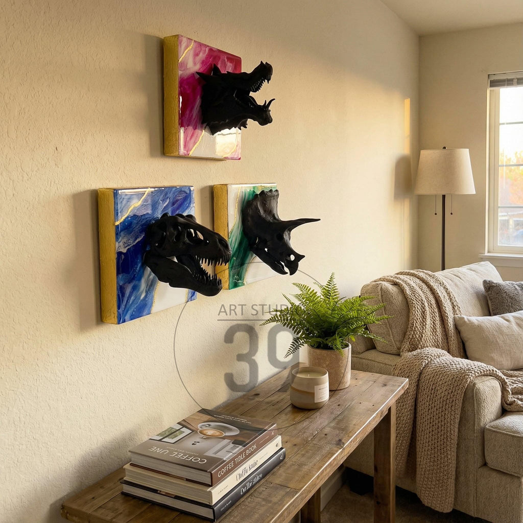 Three dinosaur skull wall art pieces. Each piece features a black dinosaur skull mounted on a square canvas with colorful abstract backgrounds in pink, blue, and green. The canvases have gold edges.