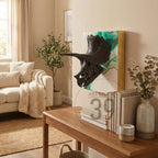 A black triceratops skull sculpture mounted on a white and green background with a gold frame. The artwork is displayed on a beige wall in a living room setting. The text "ART STUDIO 39" is visible.