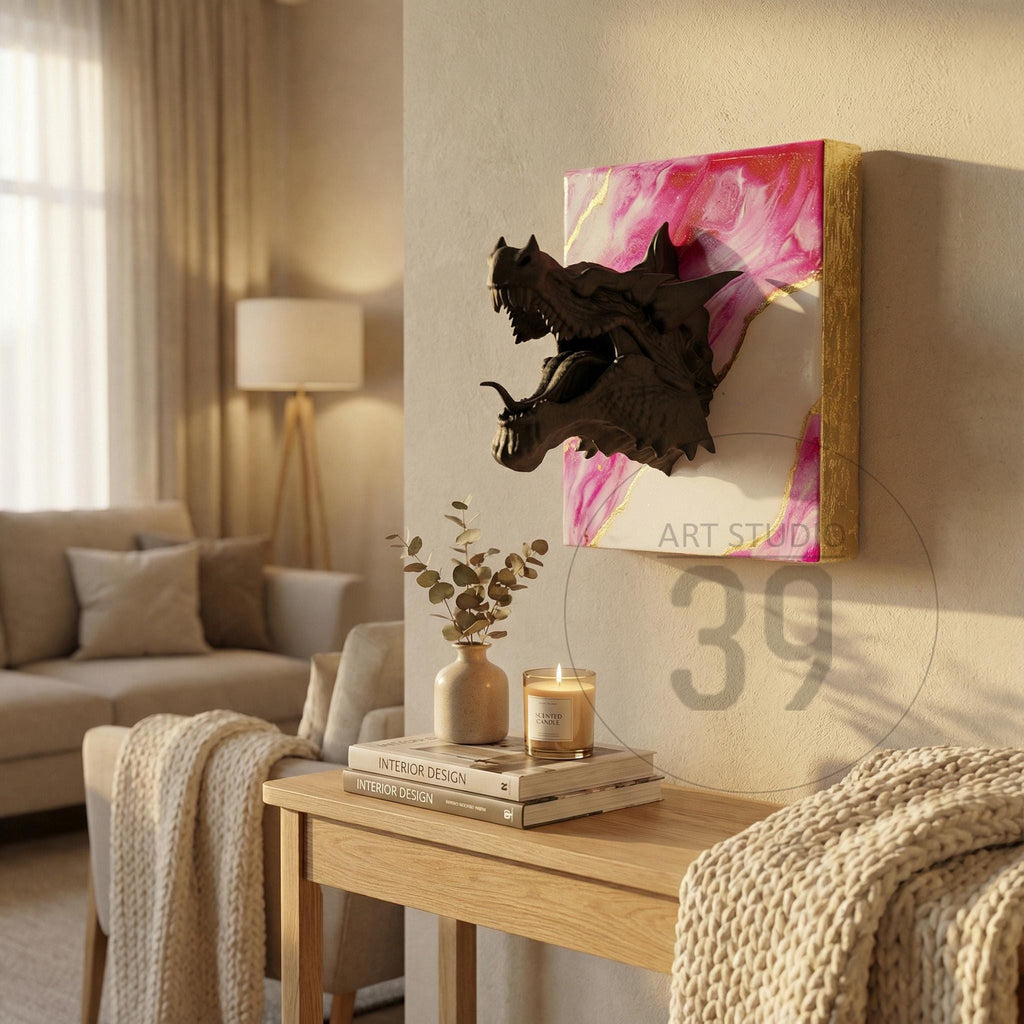 A dark bronze dragon head sculpture mounted on a canvas with pink and gold abstract art. The artwork is displayed on a wall in a living room setting. The text "ART STUDIO" and the number "39" are visible.