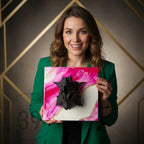 A square canvas art piece featuring a black dragon head sculpture against a pink and white marbled background with gold accents. The art piece is held by a person wearing a green blazer. The text "ART STUDIO 39" is visible.