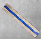 Wooden decorative piece with a vibrant blue resin river running through the center. The wood is light-colored, and the resin is a deep blue. The number "39" is visible on the wood. The piece is made of several rectangular blocks.