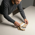 A person arranging a stack of wooden coasters with a white stripe. The coasters are made of light-colored wood and have a rectangular shape. The image includes the text "ART STUDIO 39".