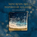 Mini resin art inspired by the Atlantic. The square artwork features a depiction of ocean waves with white foam, turquoise water, and a golden sand beach. The artwork is available in 15x15 cm and 20x20 cm sizes.