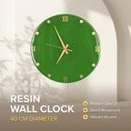 A round, green resin wall clock with gold-colored hands and Roman numeral hour markers. The clock has a 40 cm diameter and features the text "RESIN WALL CLOCK". The clock is a modern design with silent movement and a vibrant accent.