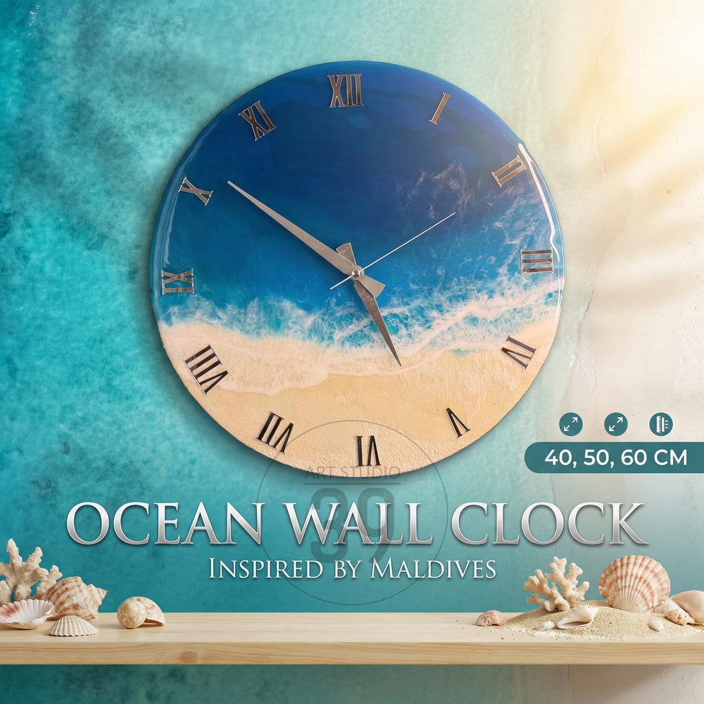Round wall clock with a beach and ocean design. The clock face features a blue ocean, white waves, and a sandy beach. Roman numerals mark the hours. The clock is available in 40, 50, and 60 cm sizes. The text "OCEAN WALL CLOCK INSPIRED BY MALDIVES" is displayed.