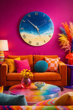 A vibrant living room scene featuring a large, round wall clock with a beach-themed design. The clock has a blue ocean and sandy beach design. An orange sofa is adorned with colorful pillows. A rainbow-colored coffee table and decorative elements complete the scene.