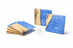 Wooden and blue resin coasters. The coasters have a square shape with a light wood grain and a blue, swirled resin design. The image also shows the text "ART STUDIO 39" in a circle.