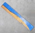 A long, rectangular wooden art piece with a blue resin river. The wood is light brown with natural grain, and the resin is a vibrant blue. The number "39" is visible in a circle on the wood. The piece is made of several connected wooden blocks.