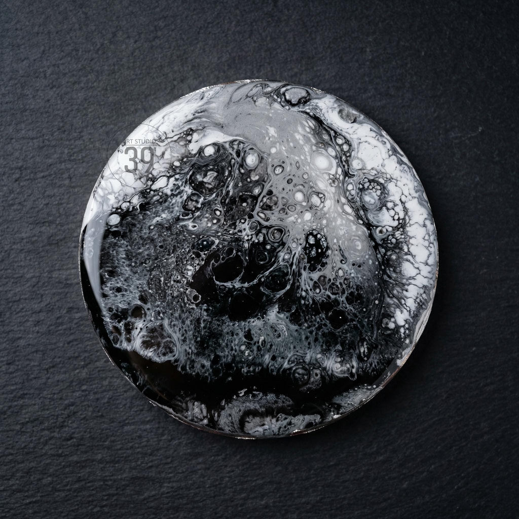 Round coaster with a black, white, and gray abstract design. The coaster has a glossy finish and a unique, marbled appearance. The text "39" is visible on the top left of the coaster. The coaster is on a black surface.