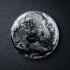 Round coaster with a black, white, and gray abstract design. The coaster has a glossy finish and a unique, marbled appearance. The text "39" is visible on the top left of the coaster. The coaster is on a black surface.