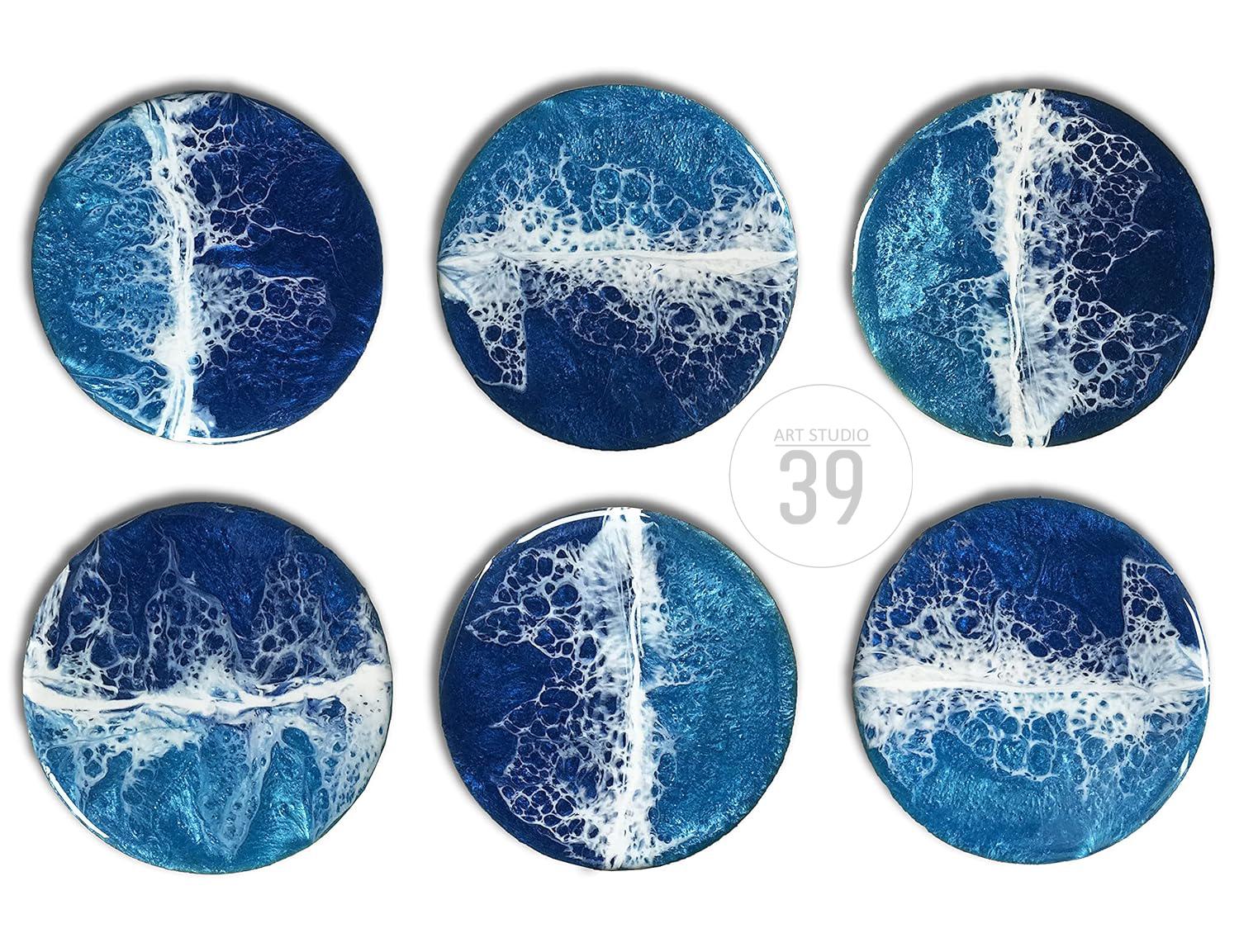 Set of six round coasters with a resin ocean wave design. The coasters feature shades of blue and white, with a glossy finish. The text "ART STUDIO 39" is in the center.