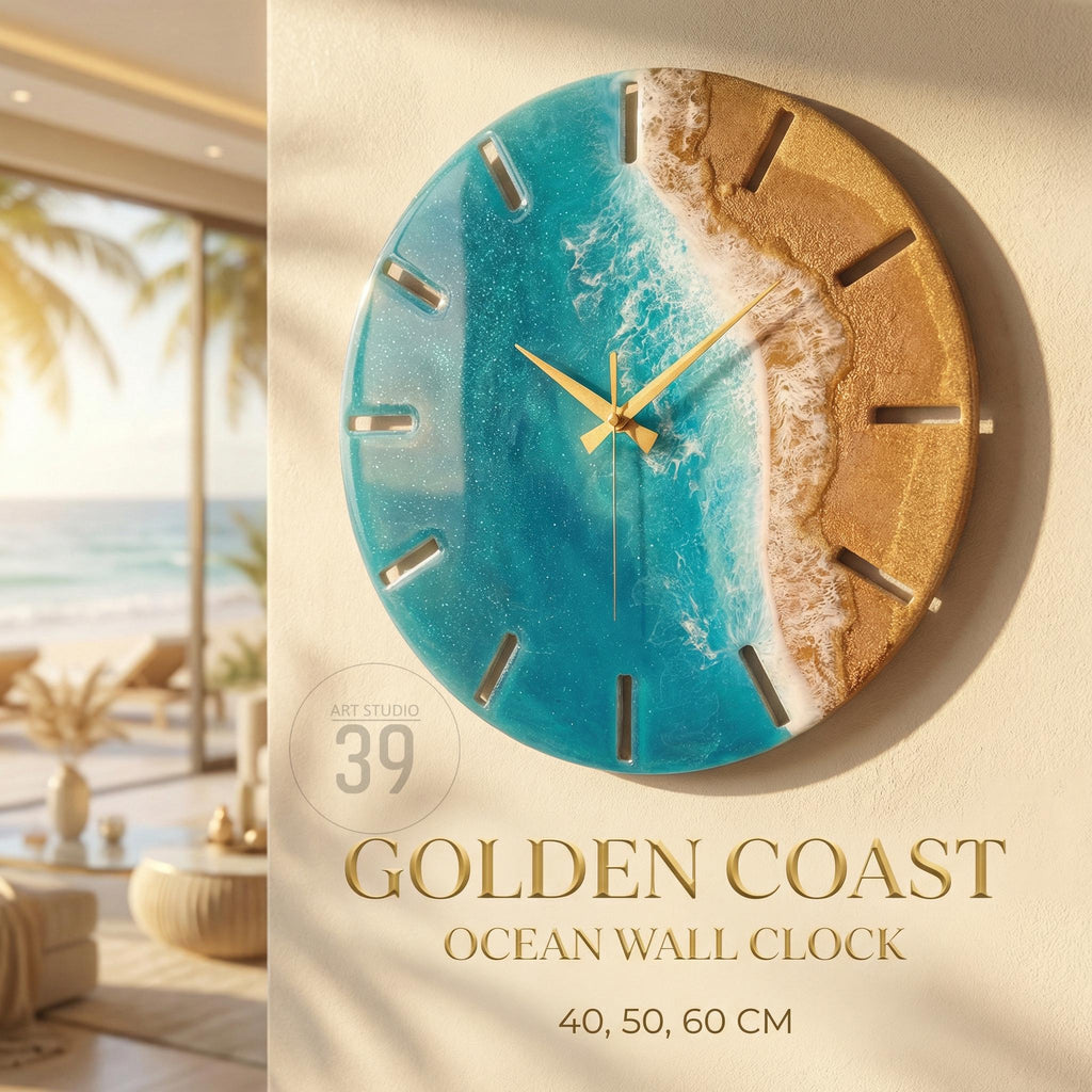 A round wall clock with a coastal theme. The clock face features a blue ocean design with a golden sand beach. The clock has gold-colored hands and a gold-colored frame. The text "GOLDEN COAST OCEAN WALL CLOCK" is displayed below the clock. The clock is available in 40, 50, and 60 cm sizes.