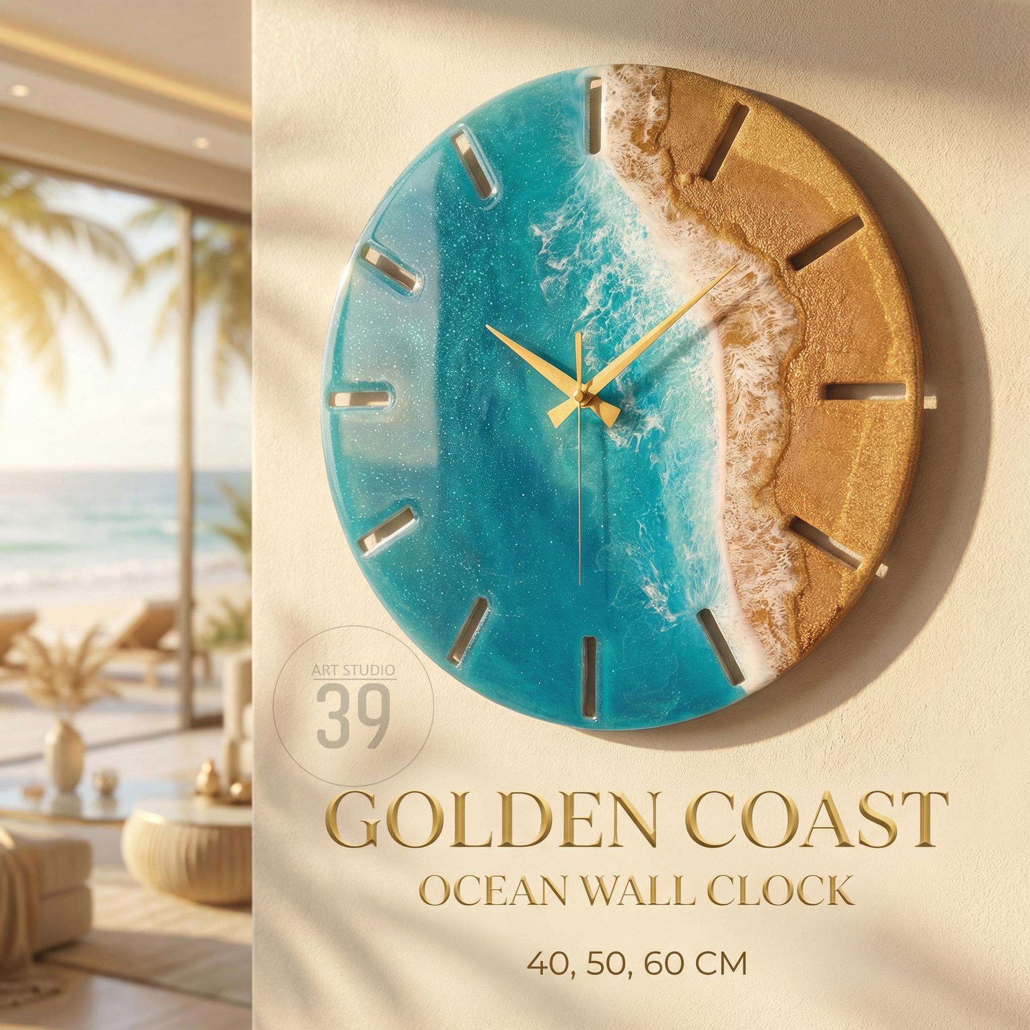 A round wall clock with a coastal theme. The clock face features a blue ocean design with a golden sand beach. The clock has gold-colored hands and a gold-colored frame. The text "GOLDEN COAST OCEAN WALL CLOCK" is displayed below the clock. The clock is available in 40, 50, and 60 cm sizes.