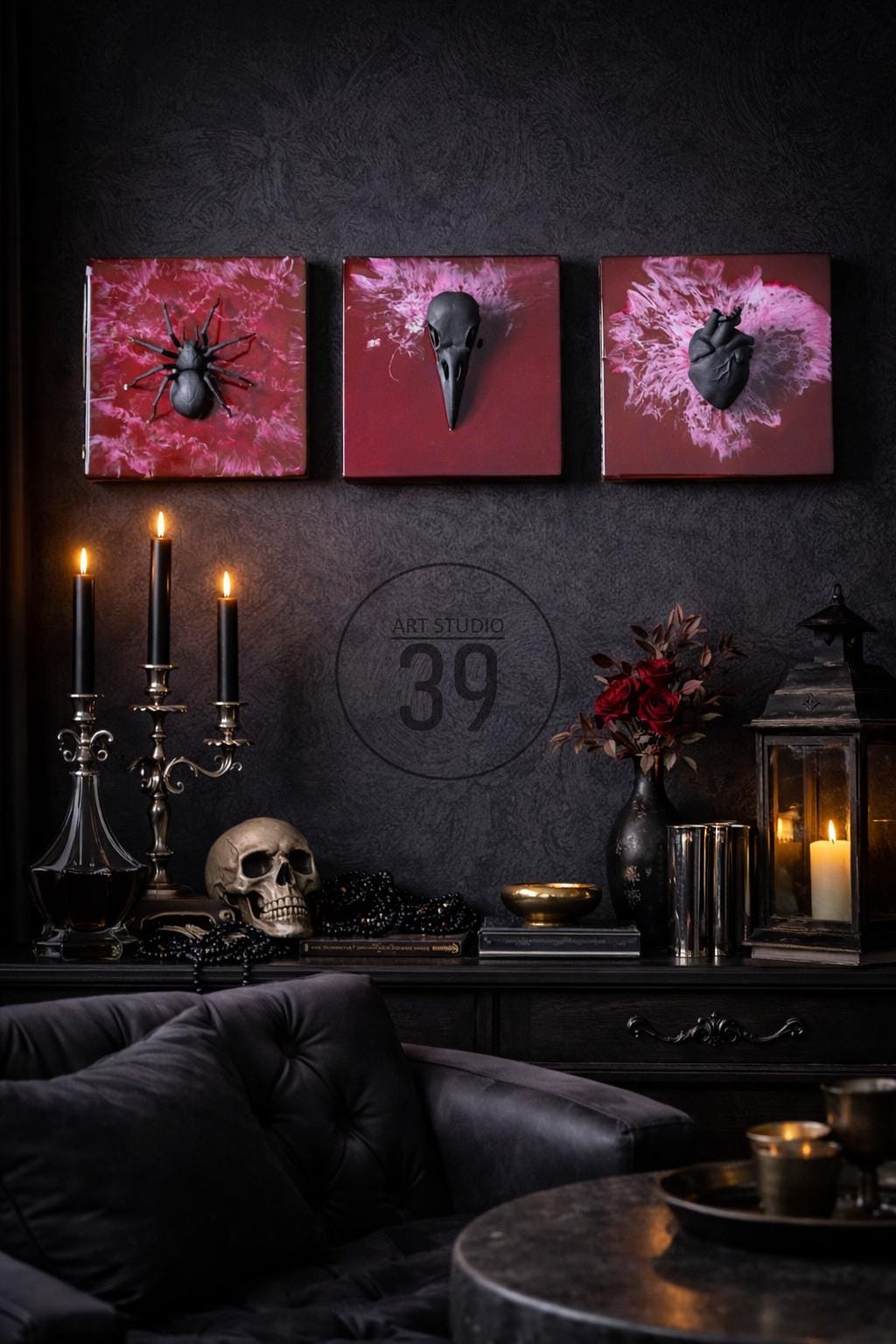 Dark, gothic-themed decor featuring three square wall art pieces with a spider, bird skull, and heart. The room includes candles, a skull, and a decorative lantern. The text "ART STUDIO 39" is visible.