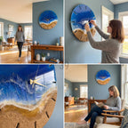 A round wall clock with a beach-themed design. The clock face features a blue resin ocean, a sandy-colored beach, and gold-colored clock hands. The clock is mounted on a blue wall in a home setting.