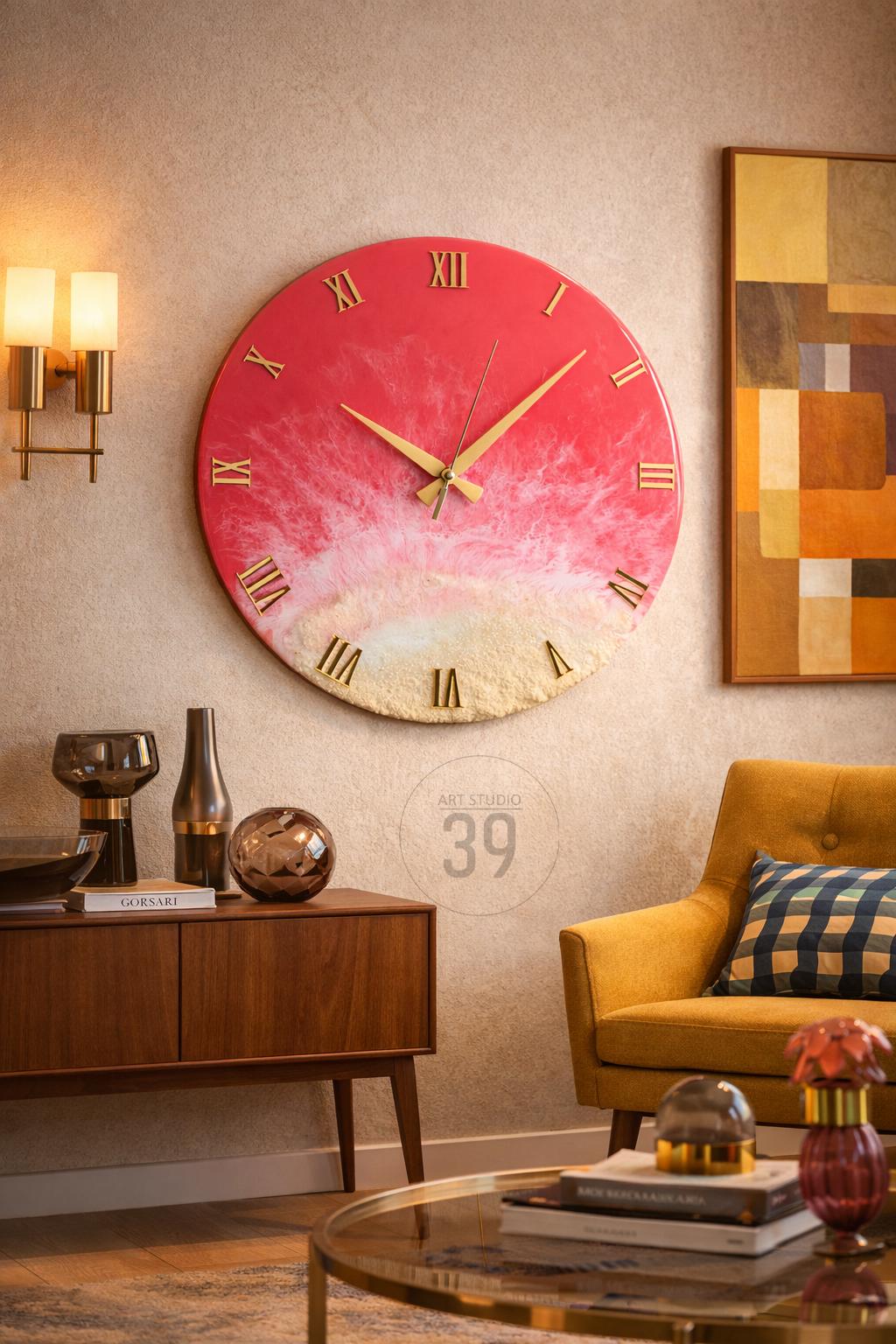 A large, round wall clock with a red and white abstract design. The clock features gold Roman numerals and hands. The clock is mounted on a beige wall, with other decorative items in the room.