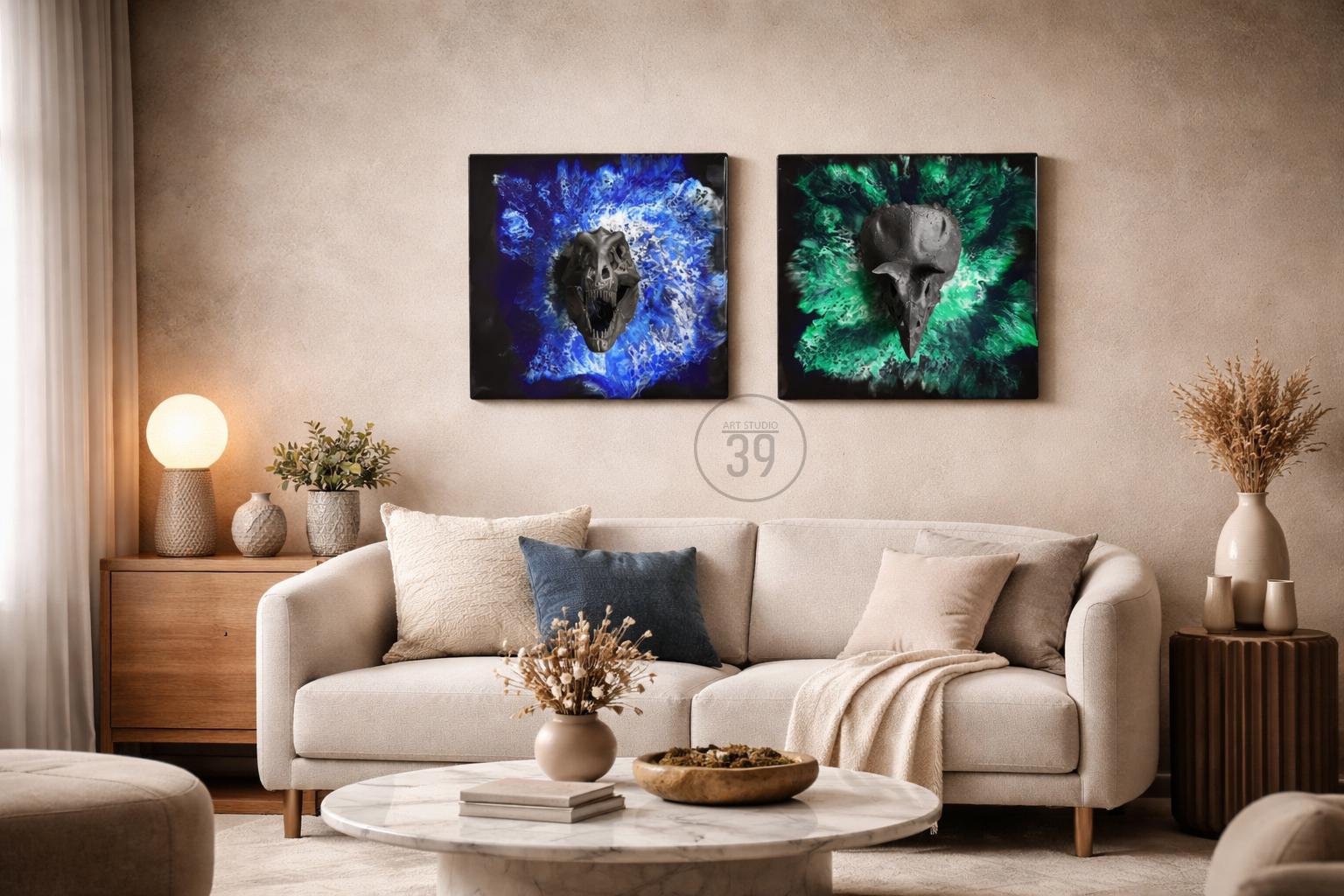 Two square canvas art pieces. One features a dinosaur skull against a blue background, the other a bird skull against a green background. The art hangs above a cream-colored sofa with decorative pillows.