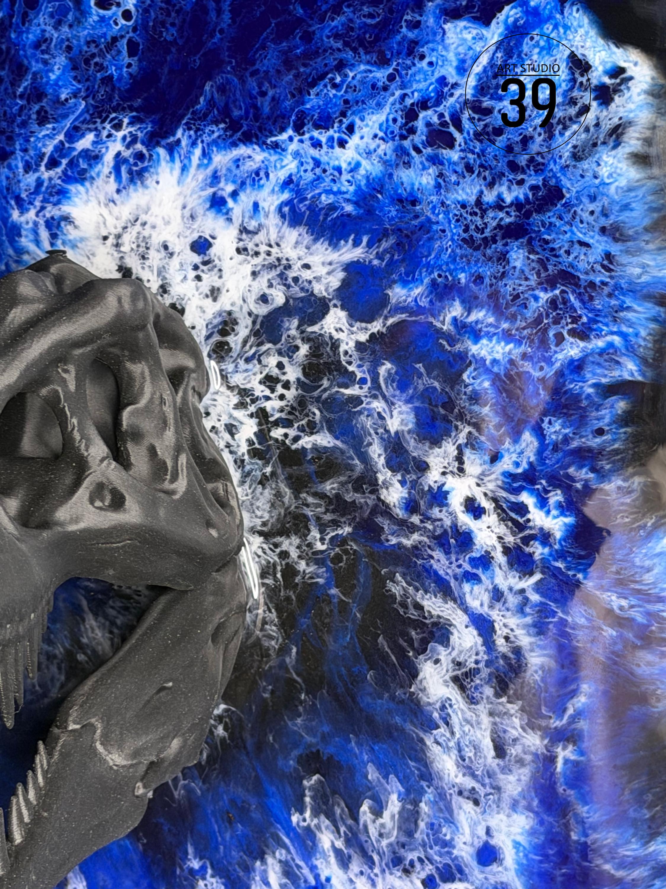 A dark gray dinosaur skull sculpture against a vibrant blue and white abstract background. The background resembles ocean waves. The image includes the text "MR STUDIO 39" in a circular logo.