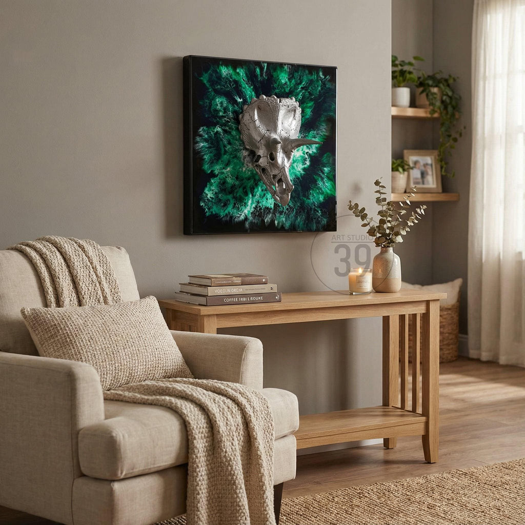 A framed artwork featuring a metallic dinosaur skull against a vibrant green and black background. The artwork is displayed above a light-colored wooden console table. The room is decorated with neutral tones and natural textures.