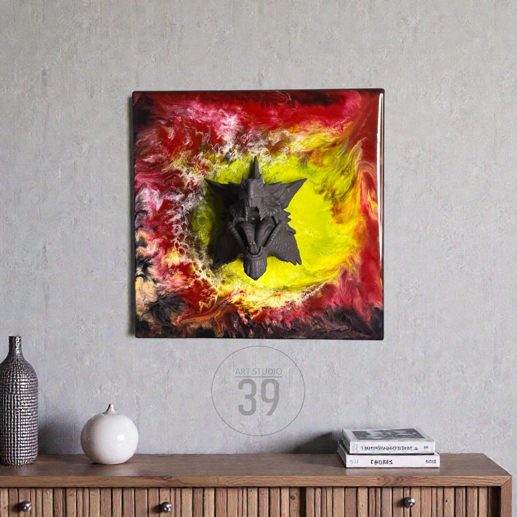 Square wall art featuring a dark gray, star-shaped sculpture on a vibrant background of red, yellow, and black swirls. The artwork is framed in a dark brown border. The art piece is mounted on a gray wall.