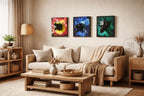 Three framed wall art pieces featuring dinosaur skull sculptures. Each canvas has a different background color: red and yellow, blue, and green. The artwork is displayed above a light-colored sofa in a living room setting.