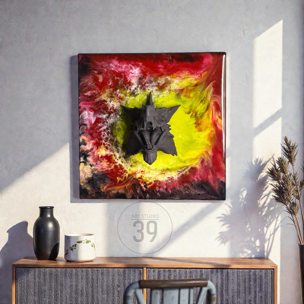 Abstract wall art featuring a dark gray, three-dimensional sculpture against a vibrant background of red, yellow, and black resin. The artwork is framed in a dark wood. The text "ART STUDIO 39" is in a circle in the lower center.