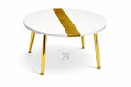 A round white coffee table with a gold stripe down the center. The table has four gold-colored legs. The table is a modern design and is suitable for a living room or lounge area.