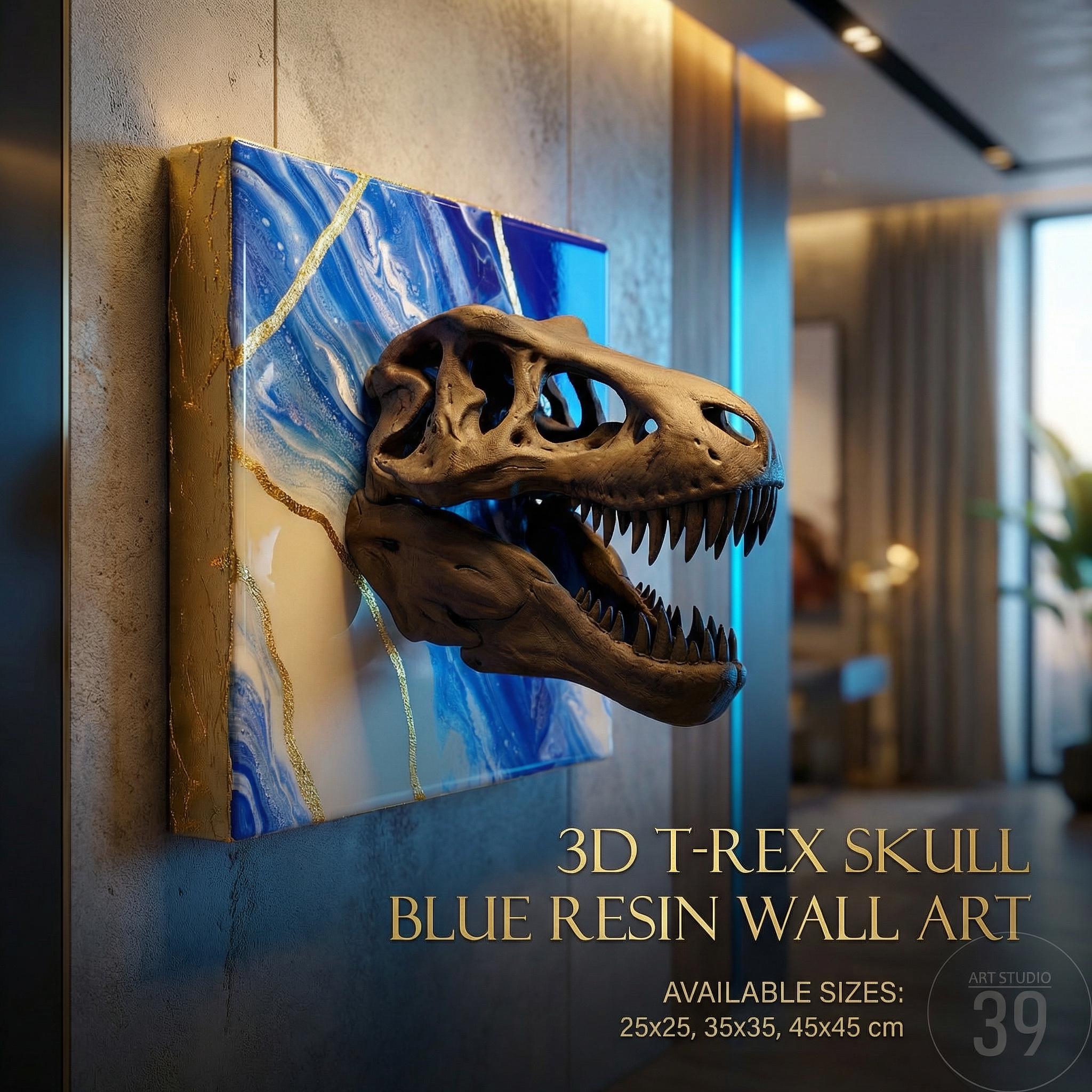 3D T-Rex skull wall art. The artwork features a detailed, brown dinosaur skull emerging from a blue and white resin background with gold accents. The text on the image reads "3D T-REX SKULL BLUE RESIN WALL ART" and "AVAILABLE SIZES: 25x25, 35x35, 45x45 cm."