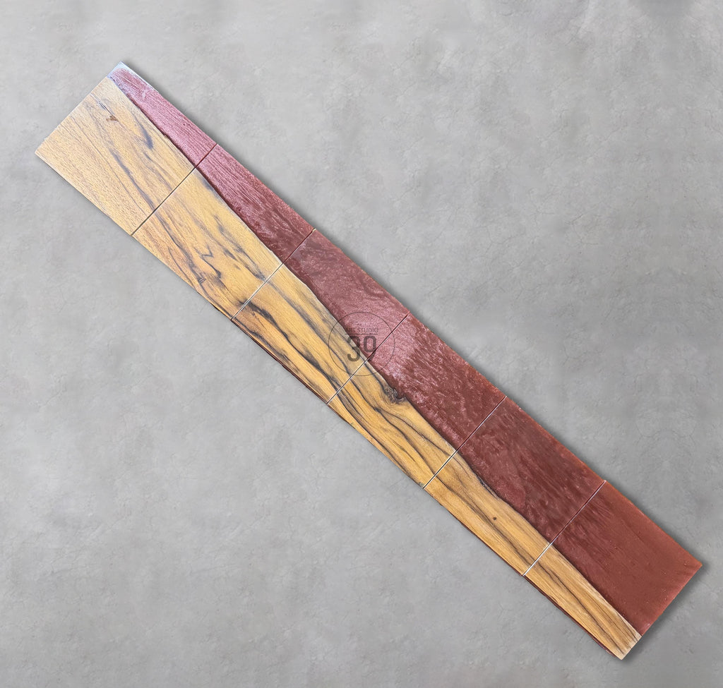 Wooden tile samples with a mix of colors and textures. The tiles are arranged diagonally, showcasing a combination of light brown, dark brown, and reddish-brown hues. The number "39" is printed on the tiles.