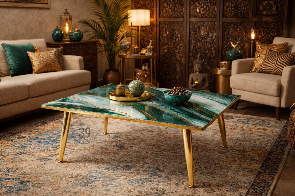 A square coffee table with a green and white marbled top and gold-colored legs. The table is in a living room setting with a sofa, chairs, and decorative items. The table measures approximately 39 inches on each side.