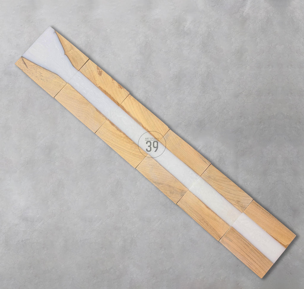 A rectangular wooden art piece with a white resin center. The wood is light brown, and the resin is opaque. The number "39" is printed in a circle on the piece.
