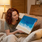 A rectangular resin art piece depicting a beach scene with a blue ocean, white waves, and a sandy shore. The artwork is held by a person. The piece has a glossy finish and is likely a decorative item.