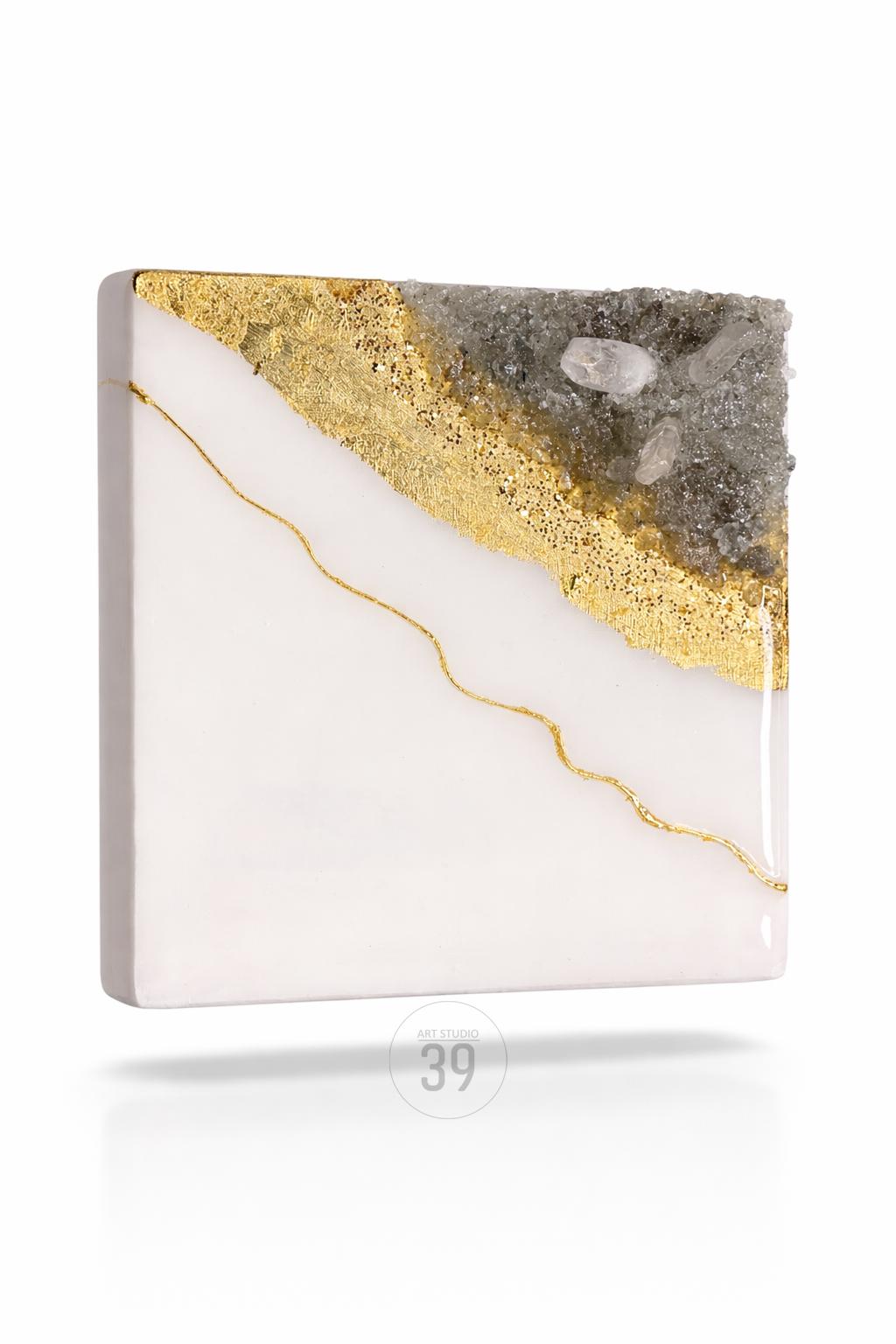 Square art piece with a white base, a diagonal section of gold glitter, and a gray, crystal-like section. A thin, gold line curves across the white area. The text "ART STUDIO 39" is at the bottom.