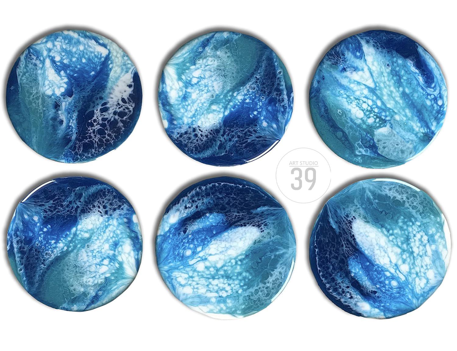 Six round coasters with an abstract ocean-like design in shades of blue and white. The coasters have a glossy finish and are arranged on a white background. The text "ART STUDIO 39" is in the center.