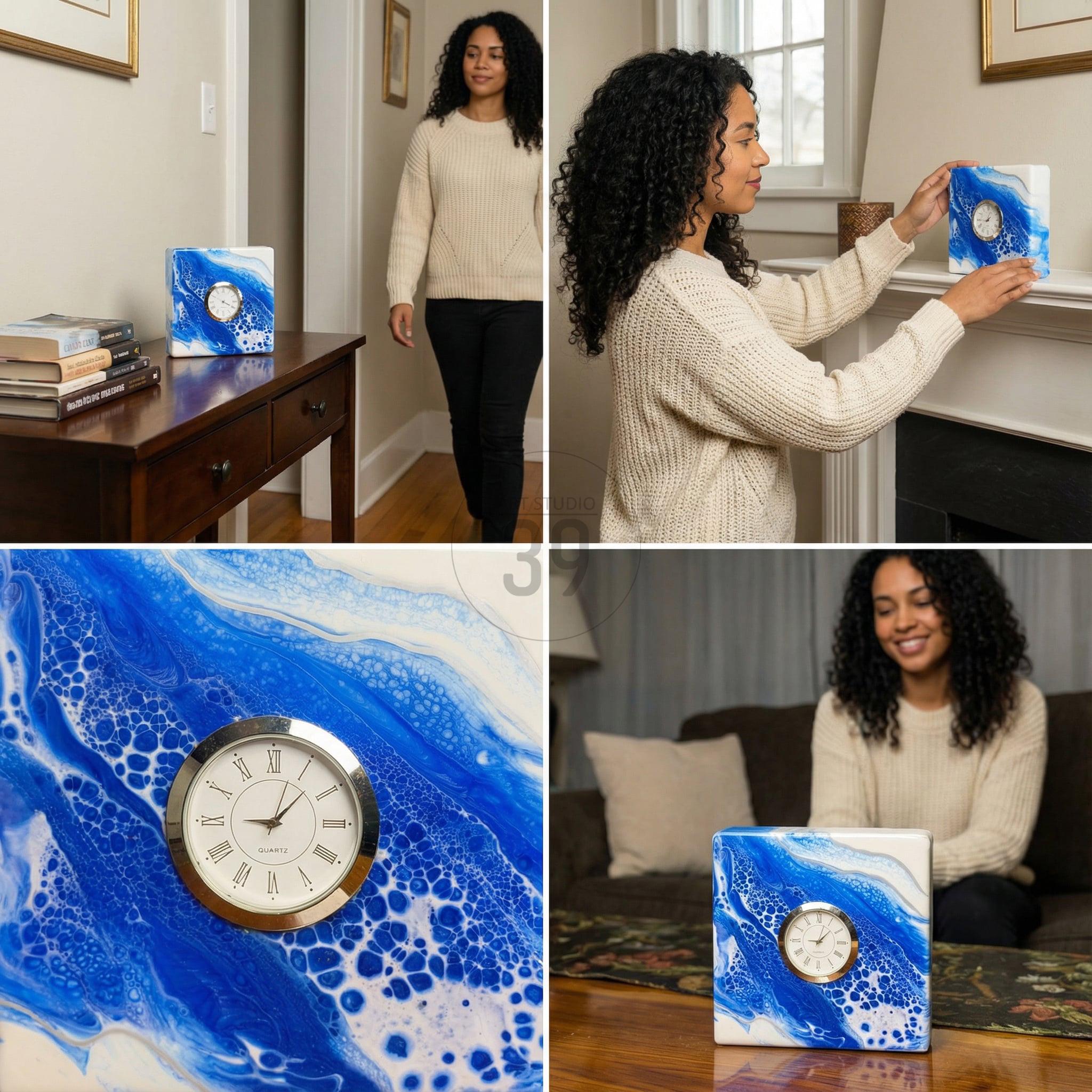 Square clock with a white face and Roman numerals, set within a silver-colored frame. The clock is mounted on a square block with a blue and white abstract design, resembling flowing water. The clock is displayed on a table and a mantel.