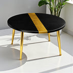 A round black coffee table with a gold stripe down the center. The table has gold-colored metal legs. The table is approximately 30 inches in diameter.