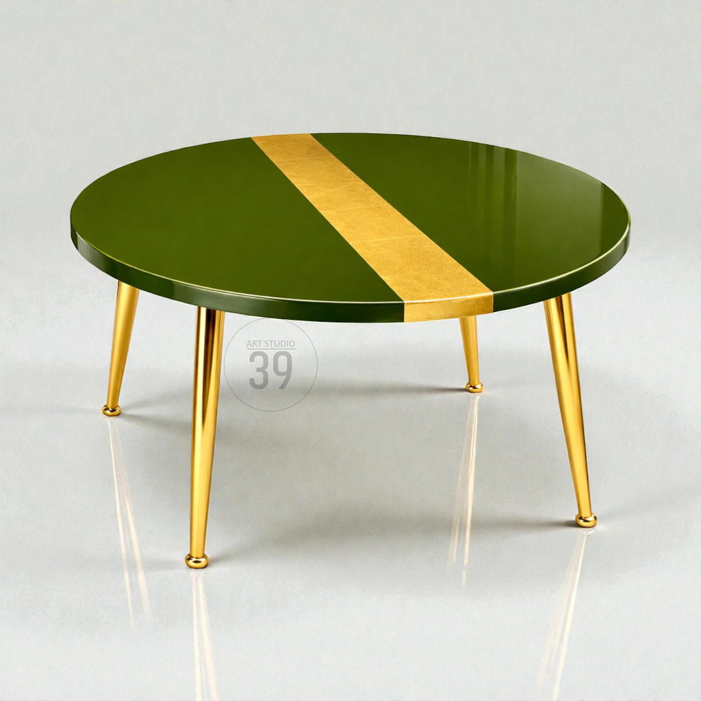 Round coffee table with a glossy olive green surface and a gold stripe down the center. The table has four gold-colored, tapered legs. The text "ART STUDIO 39" is printed on the table.