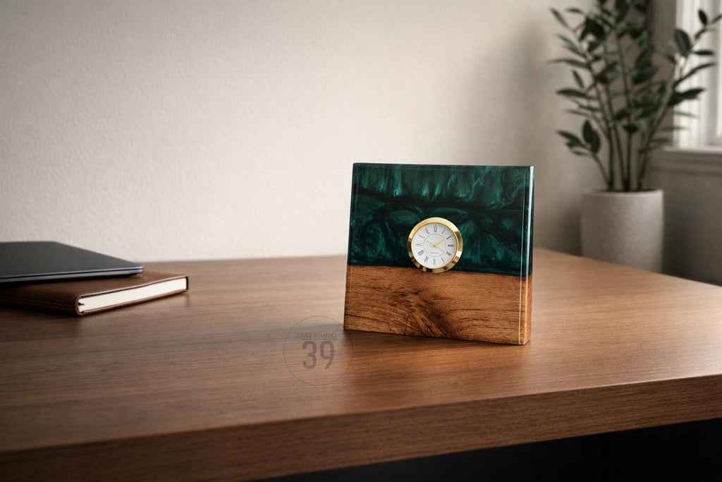 A square desk clock with a gold-tone bezel and white clock face. The top half is a dark green resin, and the bottom half is wood. The clock is on a wooden desk.