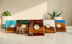 Five square wooden clocks with resin and wood grain designs. Each clock has a gold-tone bezel and a white clock face. The resin colors include blue, green, white, and brown. The clocks are displayed on a white surface.