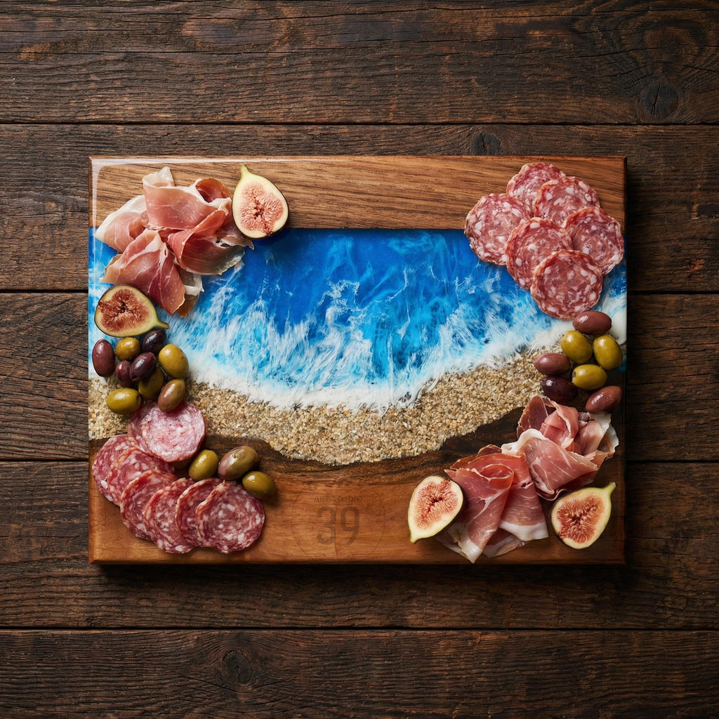 A wooden charcuterie board with a blue and white resin ocean design. The board is decorated with salami, prosciutto, olives, and figs. The number 39 is etched into the wood.