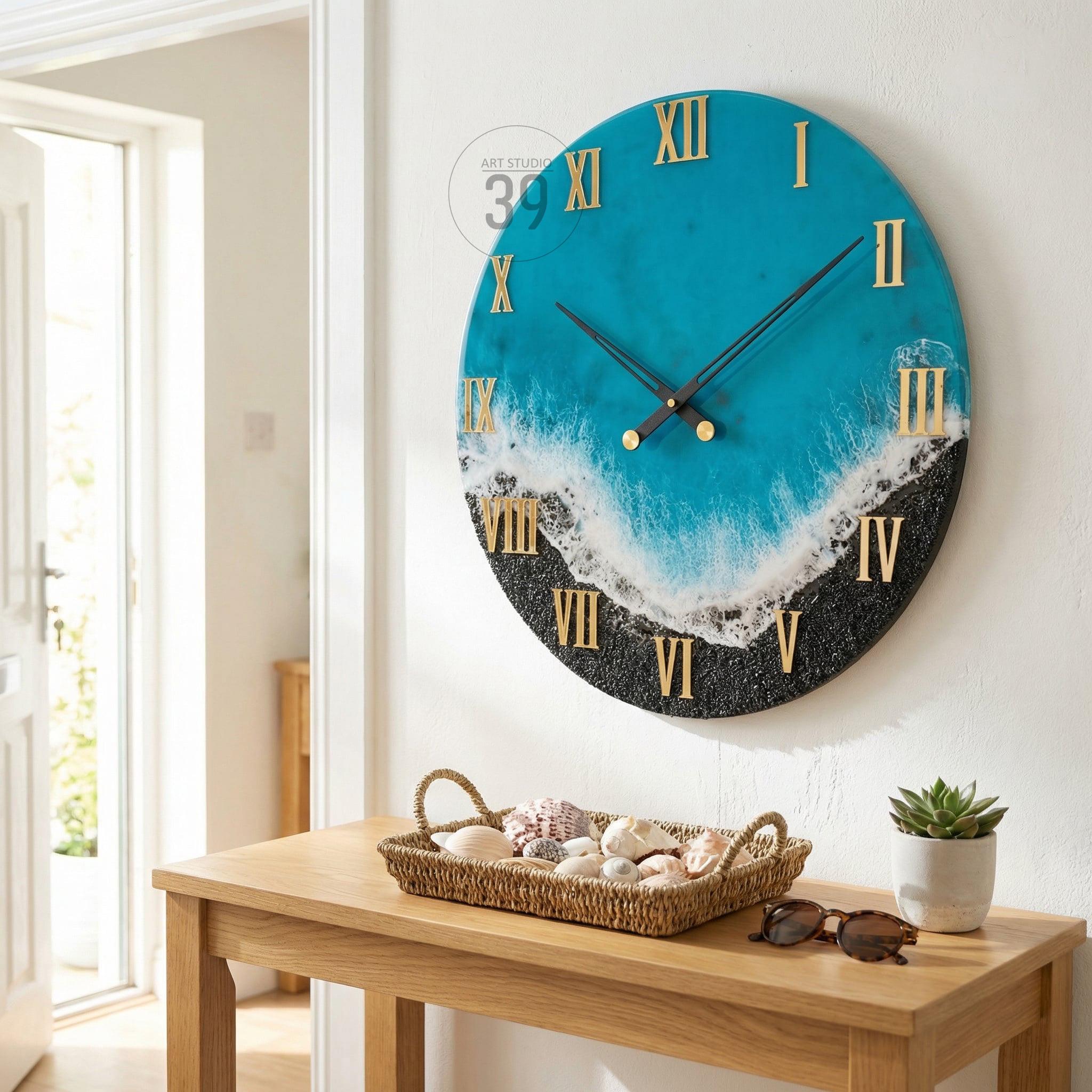 A round wall clock with a blue and black ocean-themed design. The clock face features gold Roman numerals and black clock hands. The clock is mounted on a white wall.