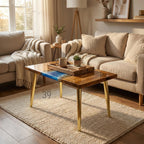 A rectangular wooden coffee table with a glossy finish and gold-colored legs. The table features a blue resin design and the number "39" printed on the side. A wooden tray with mugs and a plant sits on top.