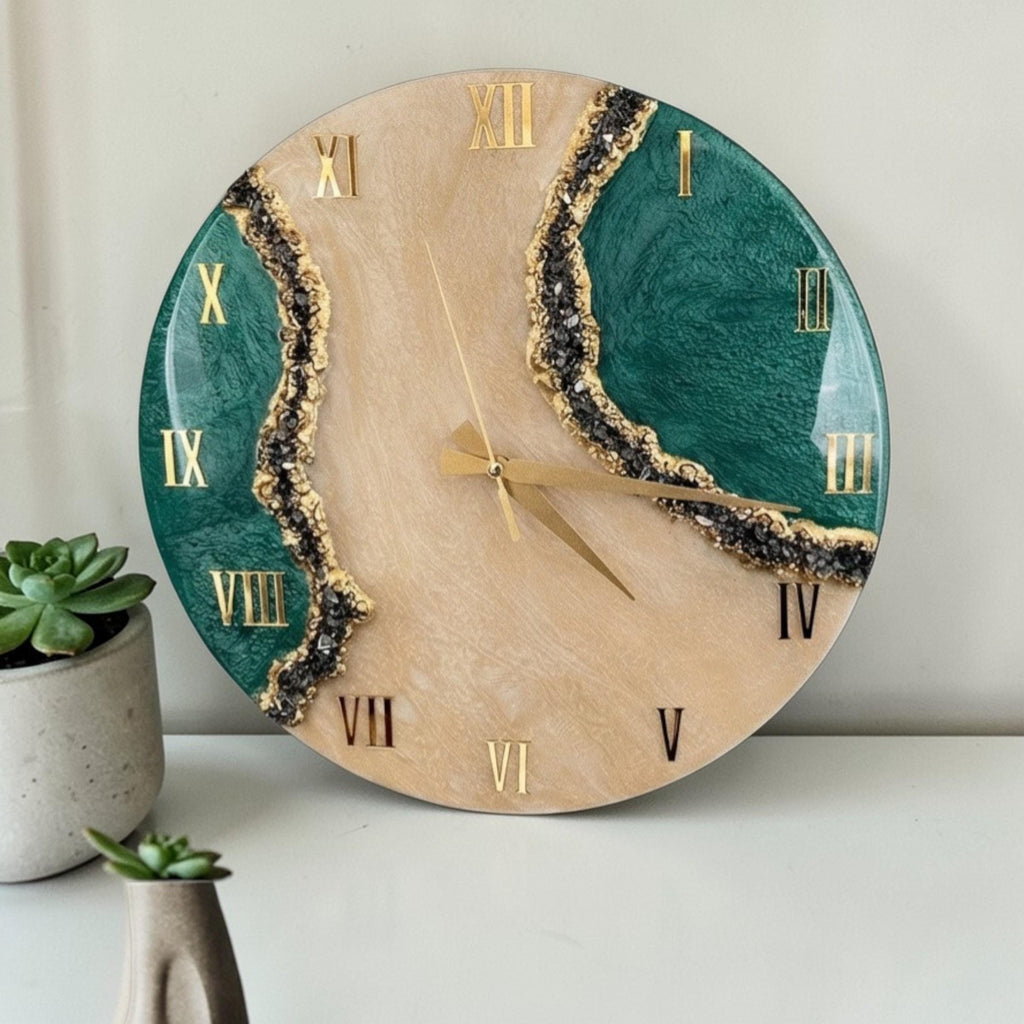 A circular wall clock featuring a beige center and two deep green side sections separated by jagged lines of dark, textured crystals. The clock face displays gold Roman numerals and thin gold hands, creating a high-contrast design.