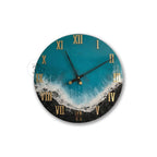 Round wall clock with a teal and black ocean-themed design. The clock face features gold Roman numerals and black clock hands. The design includes a white wave pattern and a black, textured base.